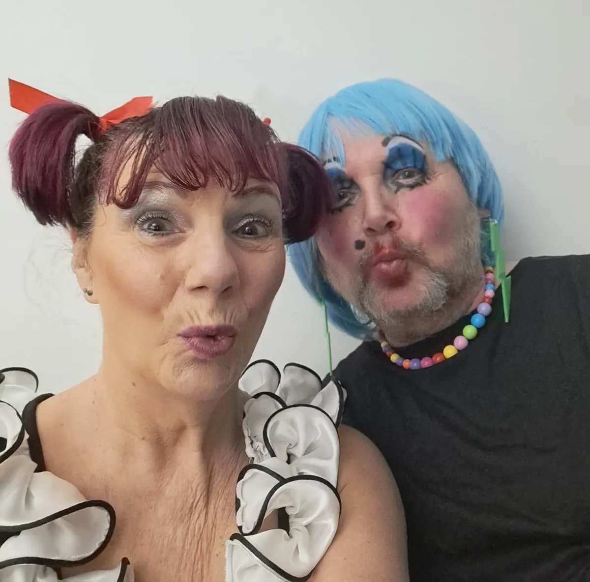 Two Robin Hood performers sharing a playful backstage moment